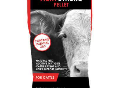 A 50-lb bag labeled "FIGHT STRONG PELLET" for cattle, showing two cows. The bag highlights essential oils, immune support, and gut health benefits. Brand: Ralco. Text indicates it assists with digestion and stress.