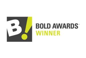 Logo featuring a large white "B!" on a dark square background, with the text "BOLD AWARDS WINNER" in black and yellow to the right.