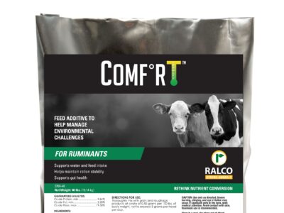 A silver bag labeled "COMFRT" features images of two cows and text indicating it is a feed additive for ruminants by Ralco, designed to help manage environmental challenges and support animal health.