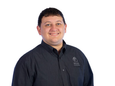 A man with short dark hair smiles at the camera. He is wearing a dark button-up shirt with the RALCO logo on the chest, standing against a plain white background.