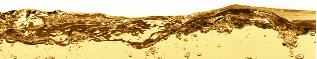 Golden-yellow liquid with bubbles and waves, likely oil or another fluid, against a white background. The image captures the motion and clarity of the liquid, emphasizing its color and texture.