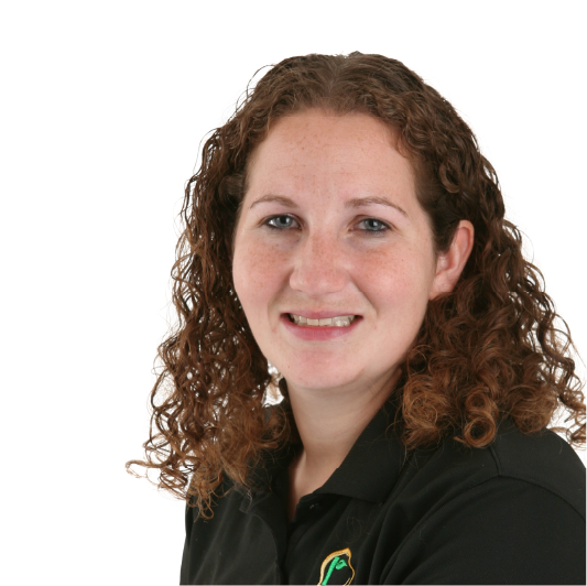 A woman with curly brown hair, wearing a black collared shirt, smiles in front of a plain white background.