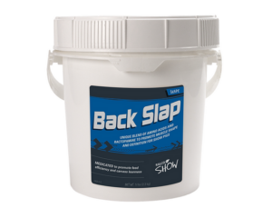 Back Slap is a white plastic tub with a handle and a blue label, marketed for show animals. The label highlights amino acids to promote muscle shape and definition.