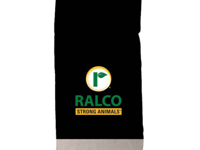 A black and white feed bag with the Ralco logo—a green leaf in a yellow circle—and “Catyl-Zyme for Dairy Cows” along with “RALCO STRONG ANIMALS” printed on the front.