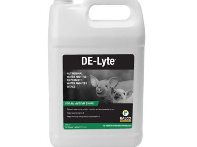A white gallon jug labeled "DE-Lyte," featuring two piglets on the front, is a nutritional water additive for swine made by Ralco.