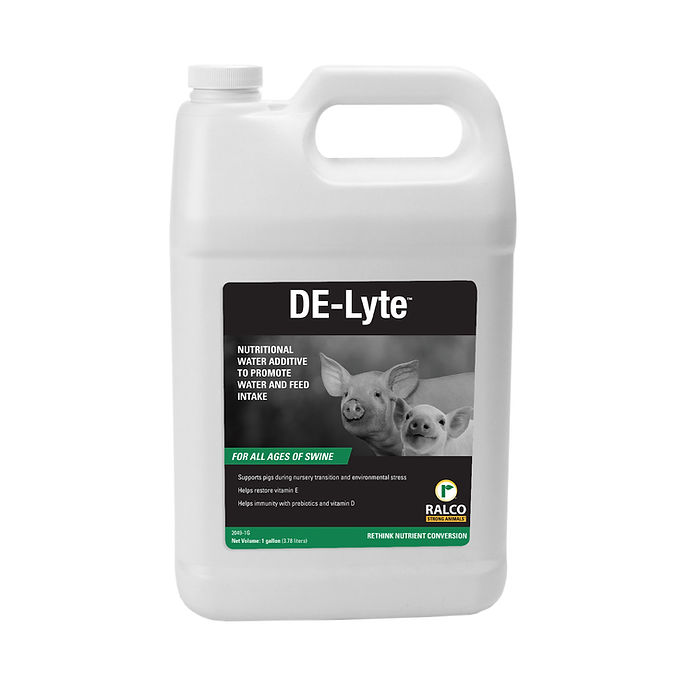 A white gallon jug labeled "DE-Lyte," featuring two piglets on the front, is a nutritional water additive for swine made by Ralco.
