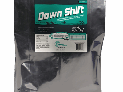 A large silver bag labeled "Down Shift" with teal and white text, described as a nutritional supplement for show livestock. The package includes detailed product information and feeding instructions.