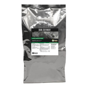 A silver bag labeled "Dual Defender," a natural swine feed supplement, features livestock images and a green-and-white information label.