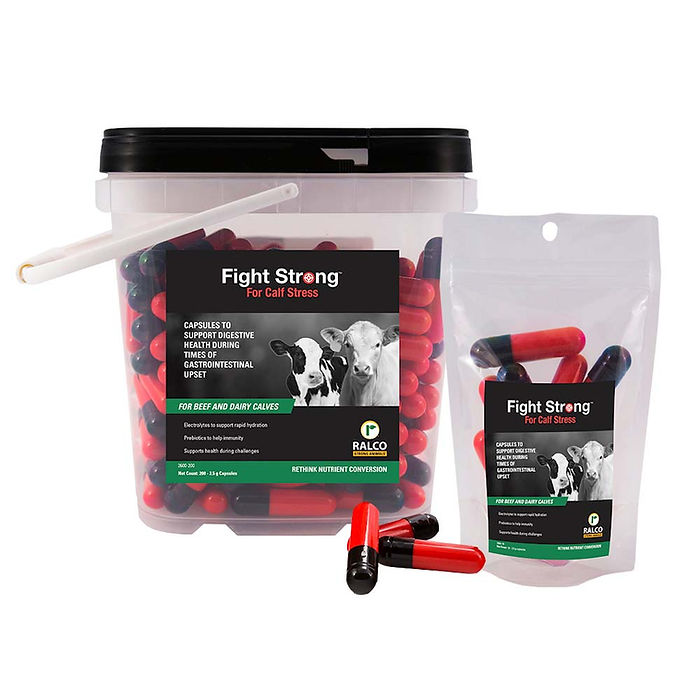 A container and pouch of Fight Strong for Calf Stress with a cow-themed label, plus several red and black capsules shown in front of the packaging.