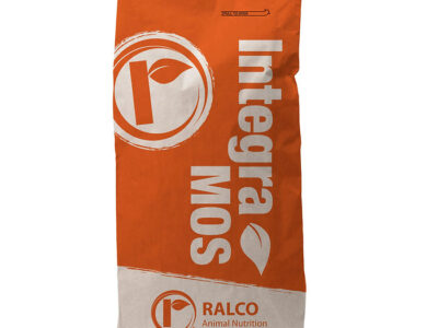 An upright, large orange and white IntegraMOS bag with a leaf logo and "RALCO Animal Nutrition" text at the bottom, plus a circular logo, stands on a plain white surface.