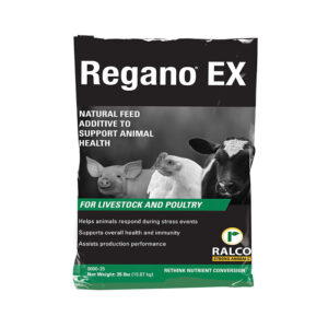 A black and white bag labeled "Regano EX Dry," a natural feed additive for livestock and poultry, displays pig, chicken, and cow images with text emphasizing health and immunity benefits.