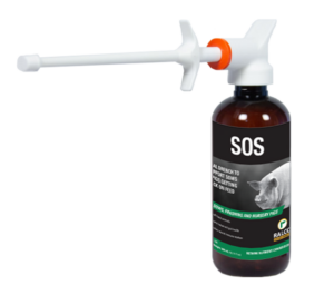 A brown SOS bottle with a long white nozzle for oral drenching in pigs; the label has a pig image and details about nutrient solutions for swine.