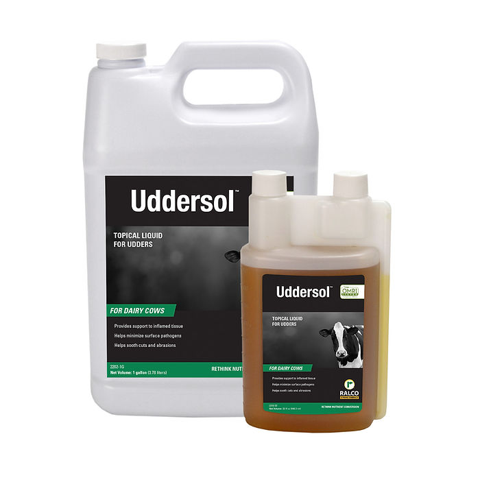Two containers of Uddersol OMRI Listed topical liquid for dairy cow udders—one large, one smaller with measuring compartments—both labeled with product info and a cow image on the front.