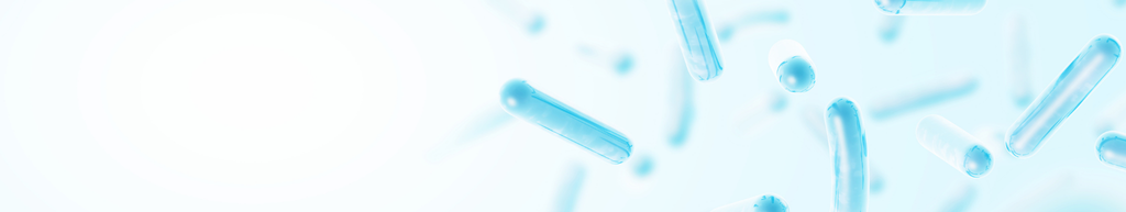 Light blue capsules floating on a soft, blurred white and blue background, creating a clean and medical-themed visual.